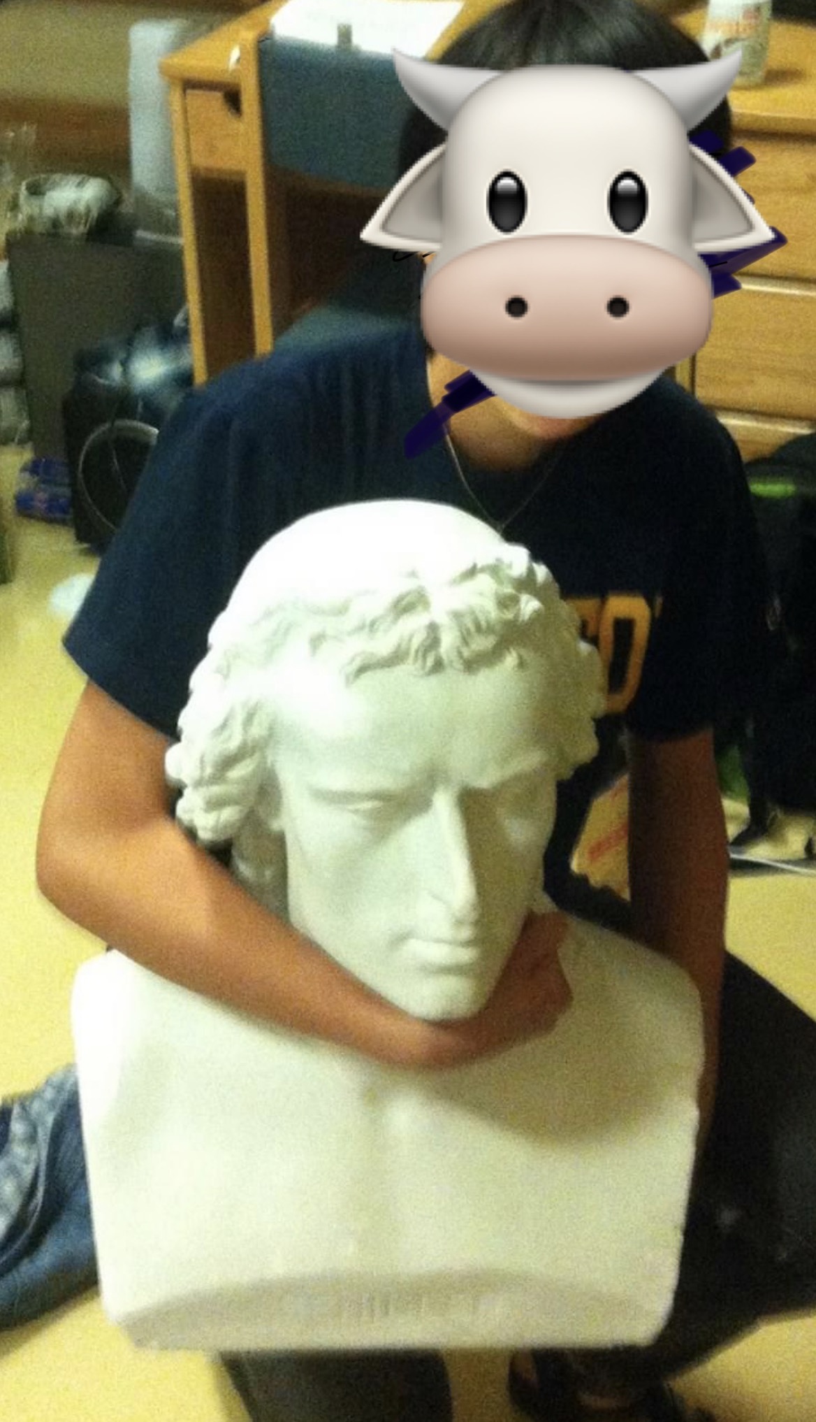 Student posing with Schiller bust